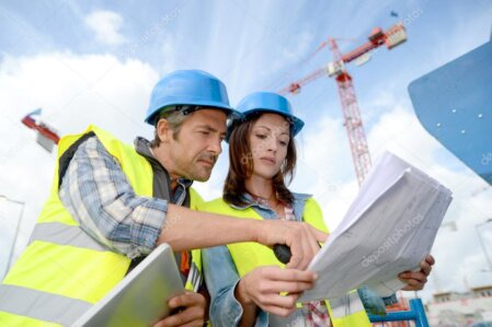 Construction supervisor in Mauritius reviewing documents on a building site